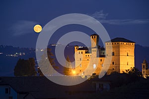 Castle of Grinzane Cavour in nocturnal with a full moon