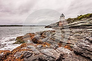 Castle Hill Lighthouse in Newport, Rhode Island, situated on a dramatic rocky coastline