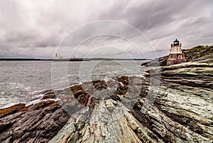 Castle Hill Lighthouse in Newport, Rhode Island, situated on a dramatic rocky coastline