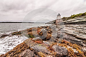 Castle Hill Lighthouse in Newport, Rhode Island, situated on a dramatic rocky coastline