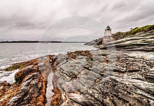 Castle Hill Lighthouse in Newport, Rhode Island, situated on a dramatic rocky coastline