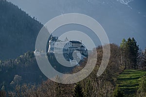 Castle Hohenwerfen at the Austrian alps, foggy morning