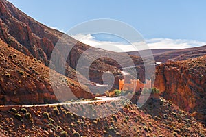 Castle kasbah hotel on the high Cliff in amazing place at Picturesque Serpentine mountain road in Gorges Dades in high