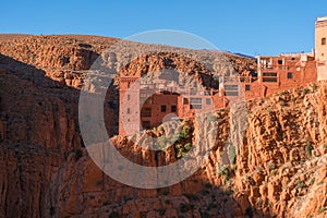 Castle kasbah hotel on the high Cliff in amazing place at Picturesque Serpentine mountain road in Gorges Dades in high