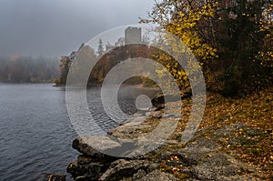 Castle Lichtenfels In Autumnal Landscape With Foggy Lake Ottenstein In Austria