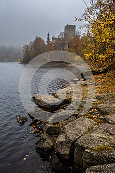 Castle Lichtenfels In Autumnal Landscape With Foggy Lake Ottenstein In Austria