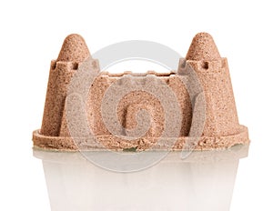 Castle made of sand isolated on white background.