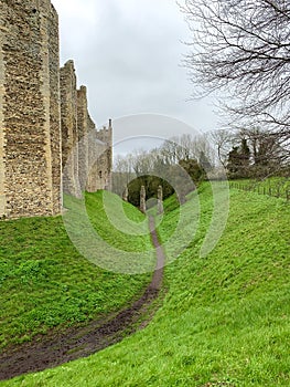 Castle moat is now a green grassy bank with footpath