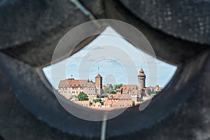 The castle of Nuremberg seen through a stone wall as a frame on