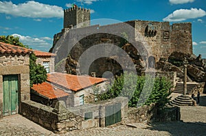 Castle and old houses encircling square with pillory