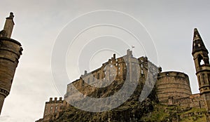 Castle Rock and Edinburgh Castle, seen from below and framed by a chimney and spire