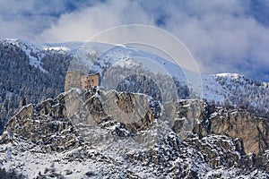 Castle on a rock in the mountains in winter time