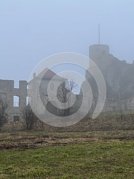 Castle ruins in Rabsztyn in Poland in rainy and foggy weather.