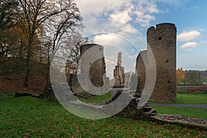 Castle ruins Ruins of a moated castle with a castle tower and castle walls surrounded by a forest and a river