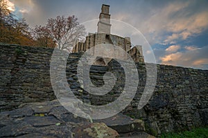 Castle ruins Ruins of a moated castle with a castle tower and castle walls surrounded by a forest and a river