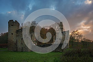 Castle ruins Ruins of a moated castle with a castle tower and castle walls surrounded by a forest and a river