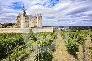 Castle Saumur, France, located at the Loire river under a beautiful sunny cloudscape during daytime