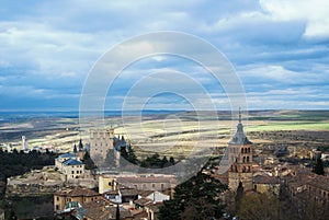 Castle of Segovia, a tower and old medieval buildings with fields at the baackground photo