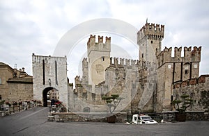 Castle in Sirmione. View to the medieval Rocca Scaligera castle 13th century in Sirmione town on Garda lake near Verona, Italy.