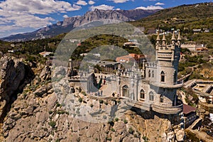 Castle Swallow`s Nest on a rock at Black Sea, Crimea. Castle is located in the urban area of Gaspra, Yalta. Aerial view