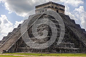 The castle and temple of Chichen Itza known as the famous and apocalyptic Mayan pyramid of Mexico under a blue sky.