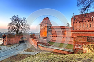 The Castle of the Teutonic Order in Malbork at sunset