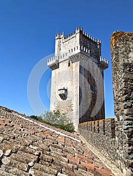 castle tower in beja, portugal (medieval european palace detail with stone wall crenellations, lantern) travel tourism