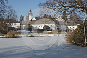 Castle Velke Losiny with a frozen pond in the park