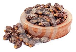 Castor beans in a wooden bowl