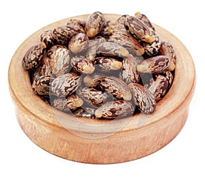 Castor beans in a wooden bowl