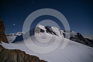 Castor and Pollux alpine peaks under starry sky