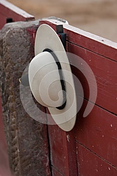 A castoreÃÂ±o (the picador's rounded hat) hanging from the barrier during a bullfight photo