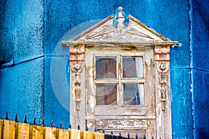 Castro, Chiloe Island, Chile - A Wooden Window Set against Tin Fencing of an Old House photo