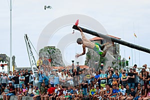 CASTRO URDIALES, SPAIN - JUNE 29: Unidentified boy holding the flag in the competition of the greasy pole celebrated in June 29