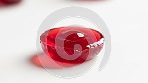 It casts a subtle red shadow on the surface emphasizing its vibrant color