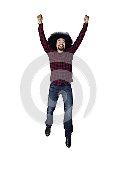 Casual Afro man jumping in studio