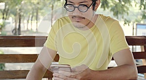 Casual asian man using smartphone .checking mails, chats