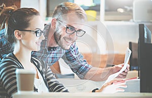 Casual business couple using computer in the office. Two colleagues working together