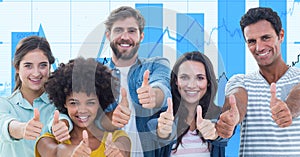 Casual business people showing thumbs up gestures against graphs