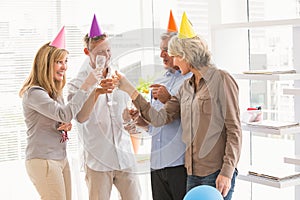 Casual business people toasting and celebrating birthday