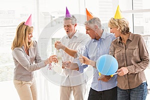 Casual business people toasting and celebrating birthday