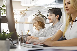 Casual business people working on computers in office