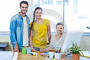 Casual business team smiling at camera during meeting