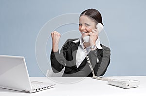 Casual business woman in office talking by phone