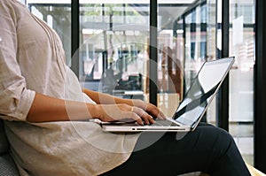 The Casual business woman works online on laptop which hand on k