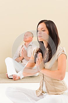 Casual business yoga woman meditating colleague