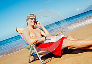 Casual Businessman Relaxing at the Beach with Laptop Computer Ta