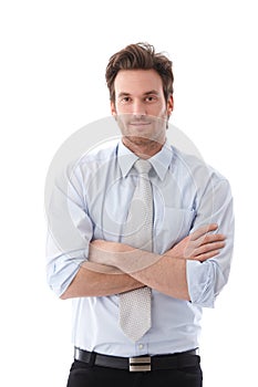 Casual businessman standing arms crossed smiling