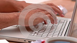 Casual businessman typing on his laptop