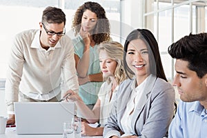 Casual businesswoman smiling at camera during meeting